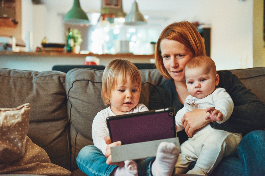 mom on ipad with kids