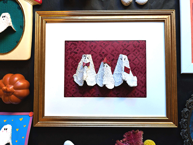 a close up photo of a family of ghosts with bows for added detail