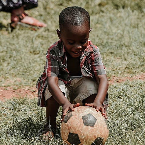 volunteer with children, play football