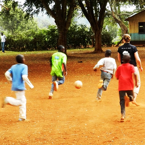 Kids in Playing Football With Volunteer in Kenya