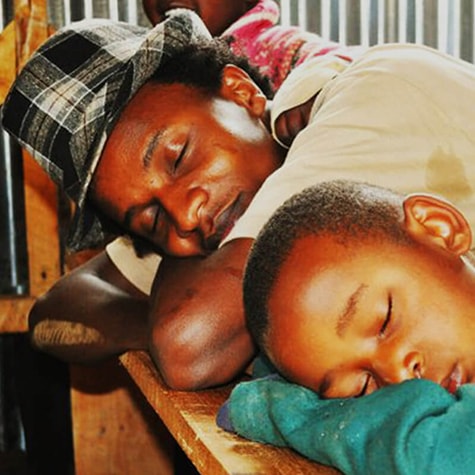 Izzo and Child Sleeping in African Classroom