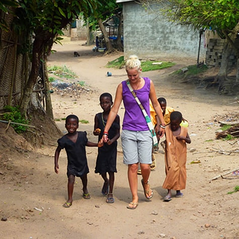 Volunteer Holding Hands With Children in Tanzania