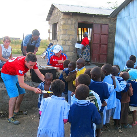 Volunteers Serving Food to Children in Kenya