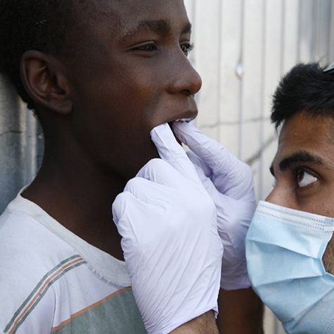 Medical volunteer Ghana checks child