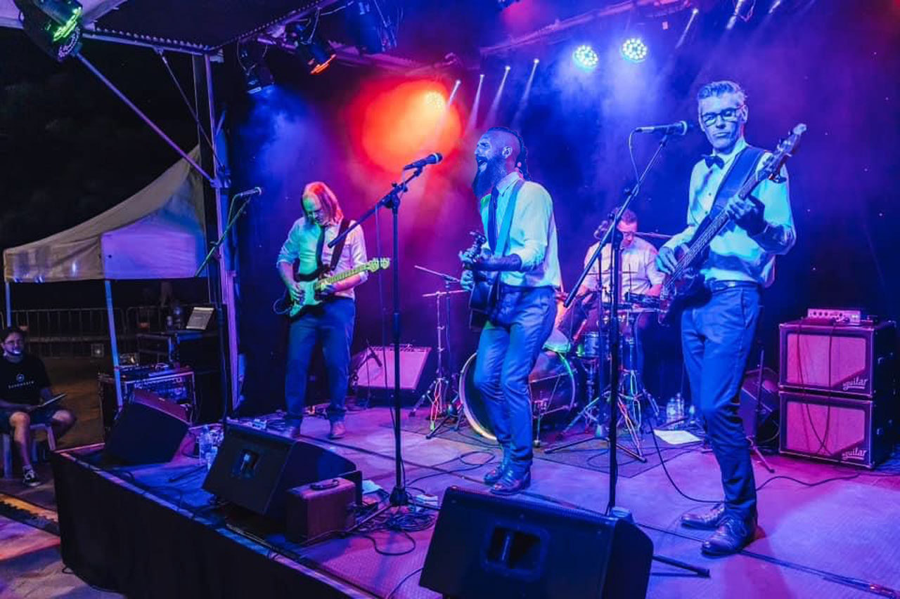 The Kens full band performing at a corporate event